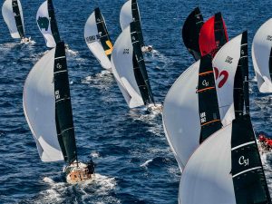 A dense fleet of Cape 31 one-design yachts racing under spinnaker, sails marked C31, including boats from Germany, Italy, Great Britain and Türkiye