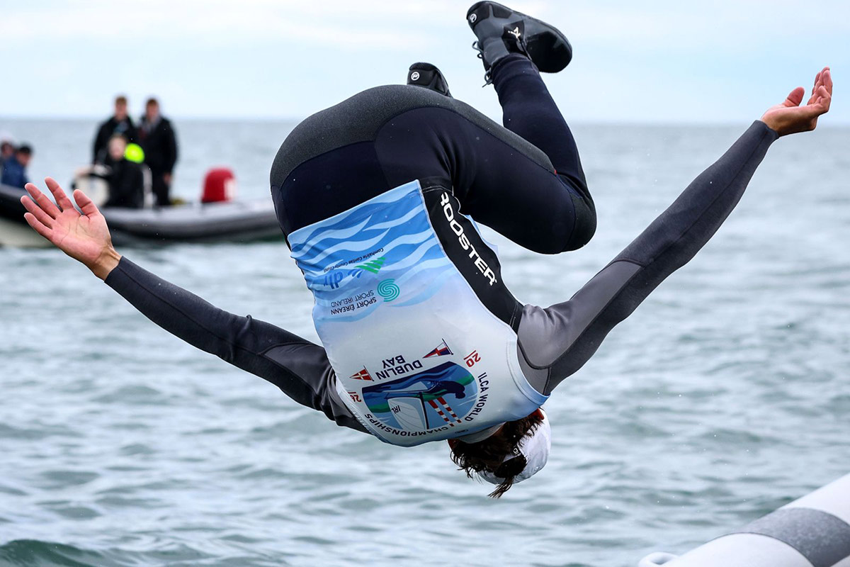 A sailor celebrates with a backflip into the water at the 2026 ILCA 7 World Championships